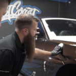 Steve from System X installing a MAX ceramic coating on a Rolls Royce at West Coast Customs