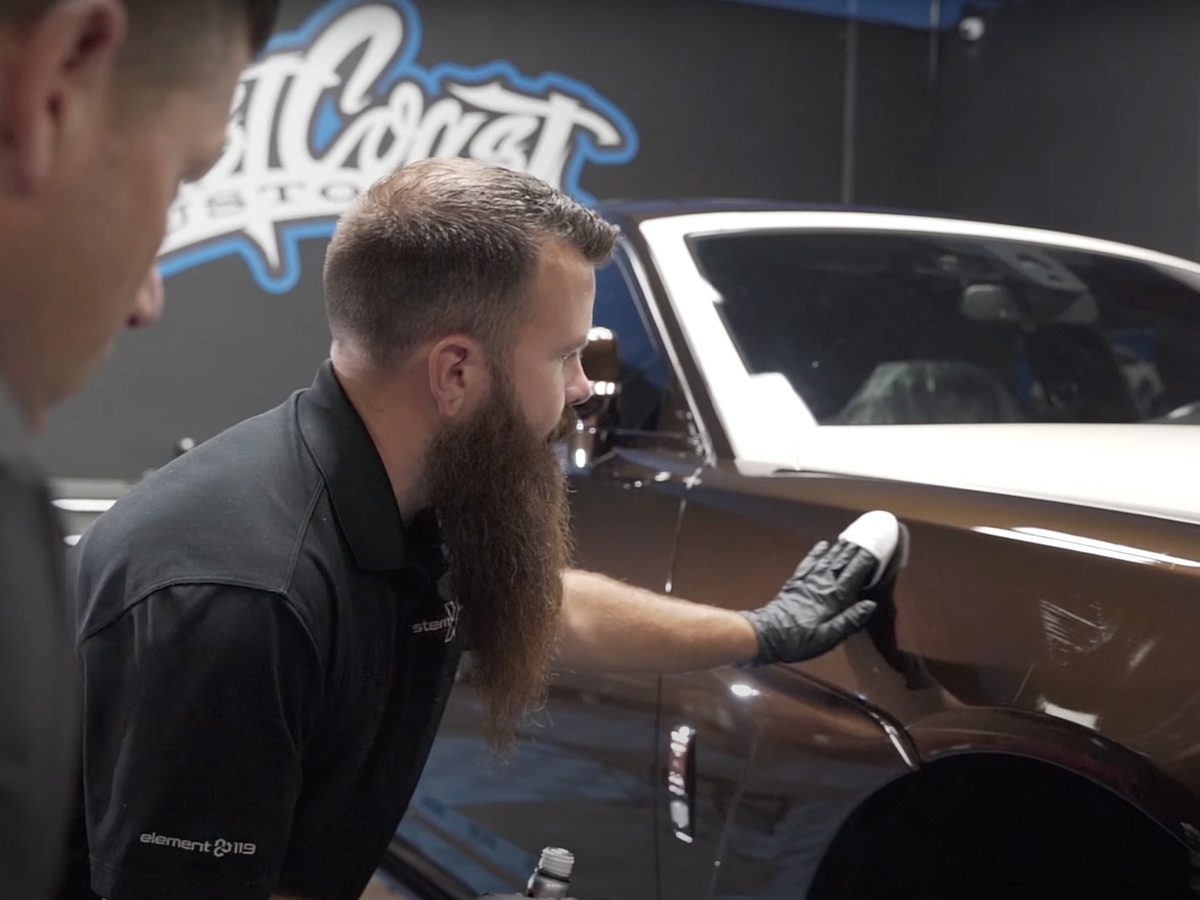 Steve from System X installing a MAX ceramic coating on a Rolls Royce at West Coast Customs