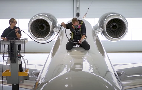 System X certified installer applying a ceramic coating on the roof of an aircraft