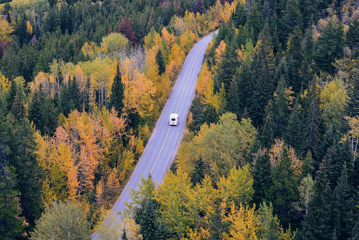 Rv driving through the wilderness during the fall