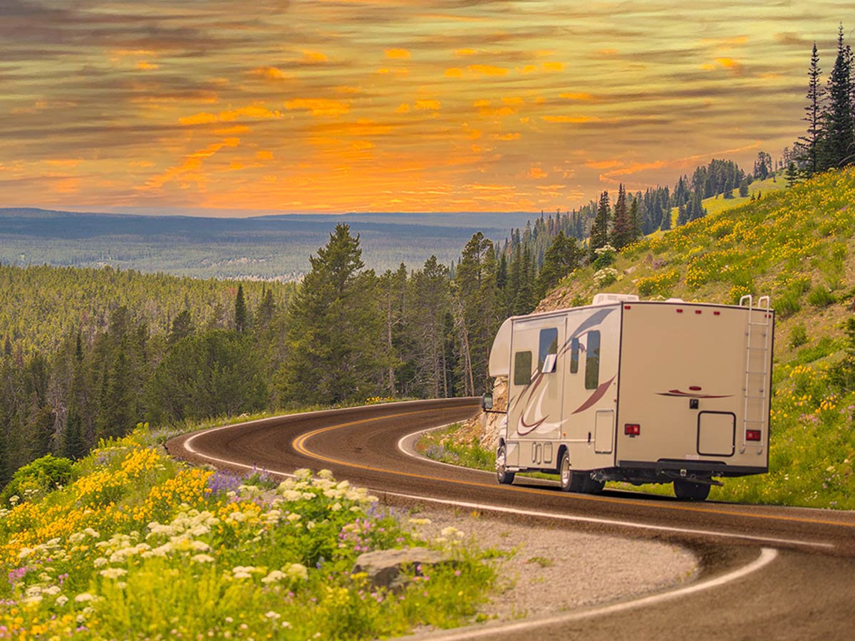 Ceramic coated RV driving down winding road in the mountains