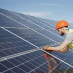 Solar panel technician inspecting a ceramic coated solar panel