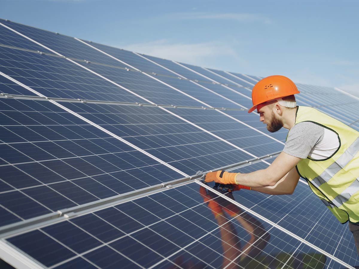 Solar panel technician inspecting a ceramic coated solar panel